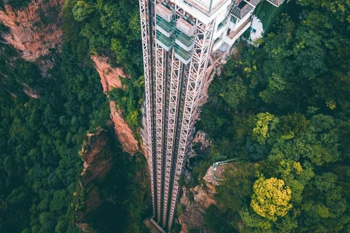 an aerial view of a tall building on a mountain
