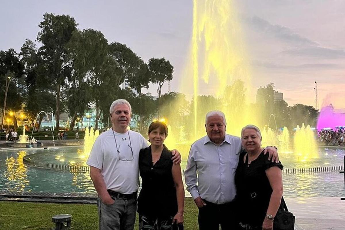 a group of people standing in front of a fountain