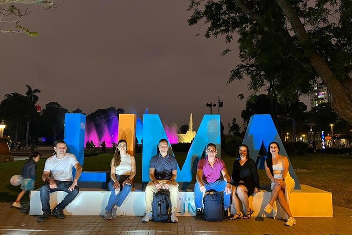 a group of people sitting in front of a large sign
