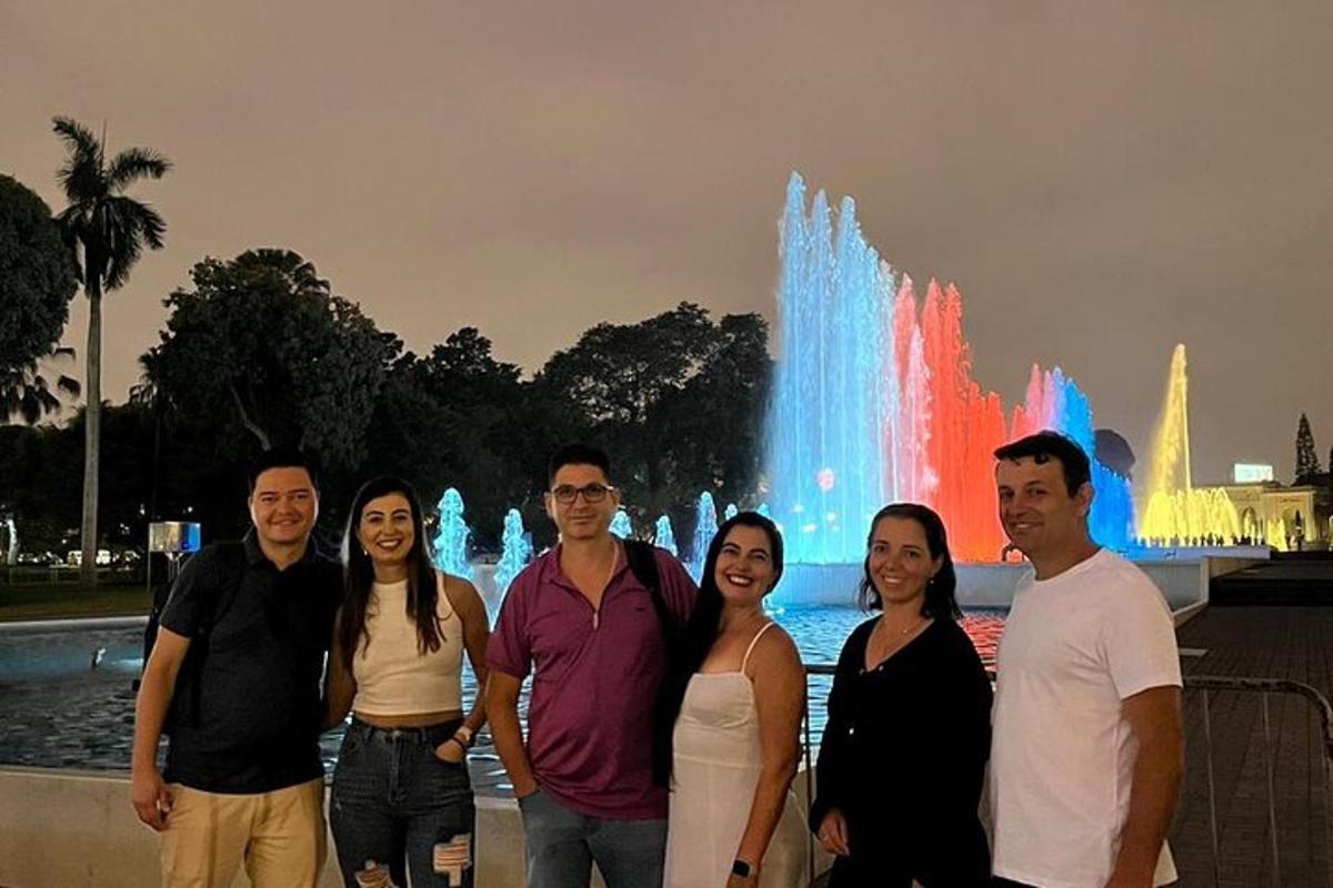 a group of people standing in front of a fountain