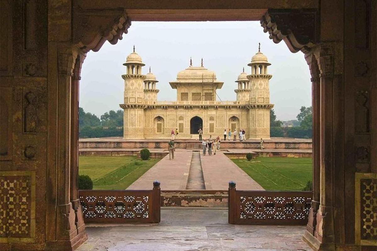 an archway leading to a building in a park