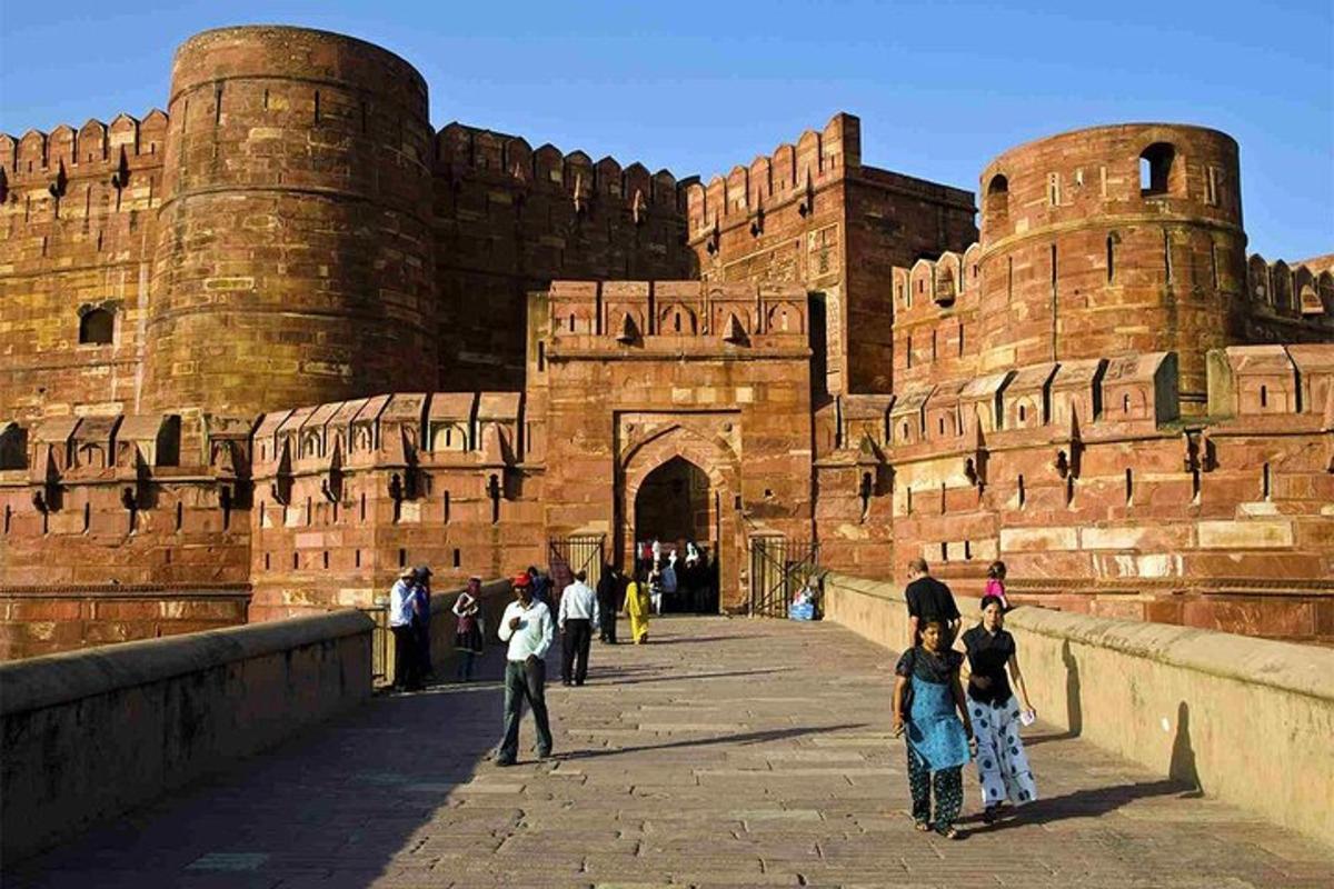 a group of people walking in front of a castle