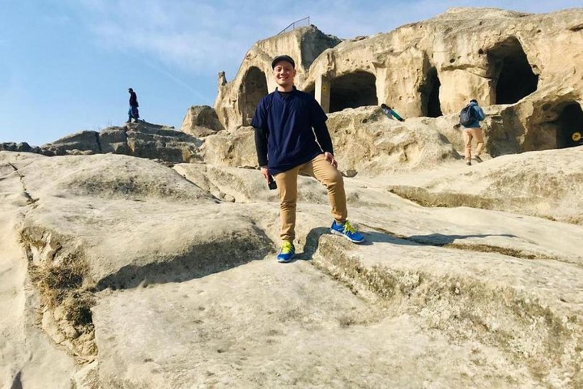 a man is standing on some rocks