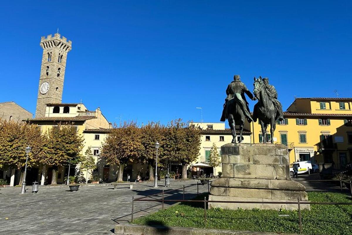 a statue of a man on a horse and a clock tower