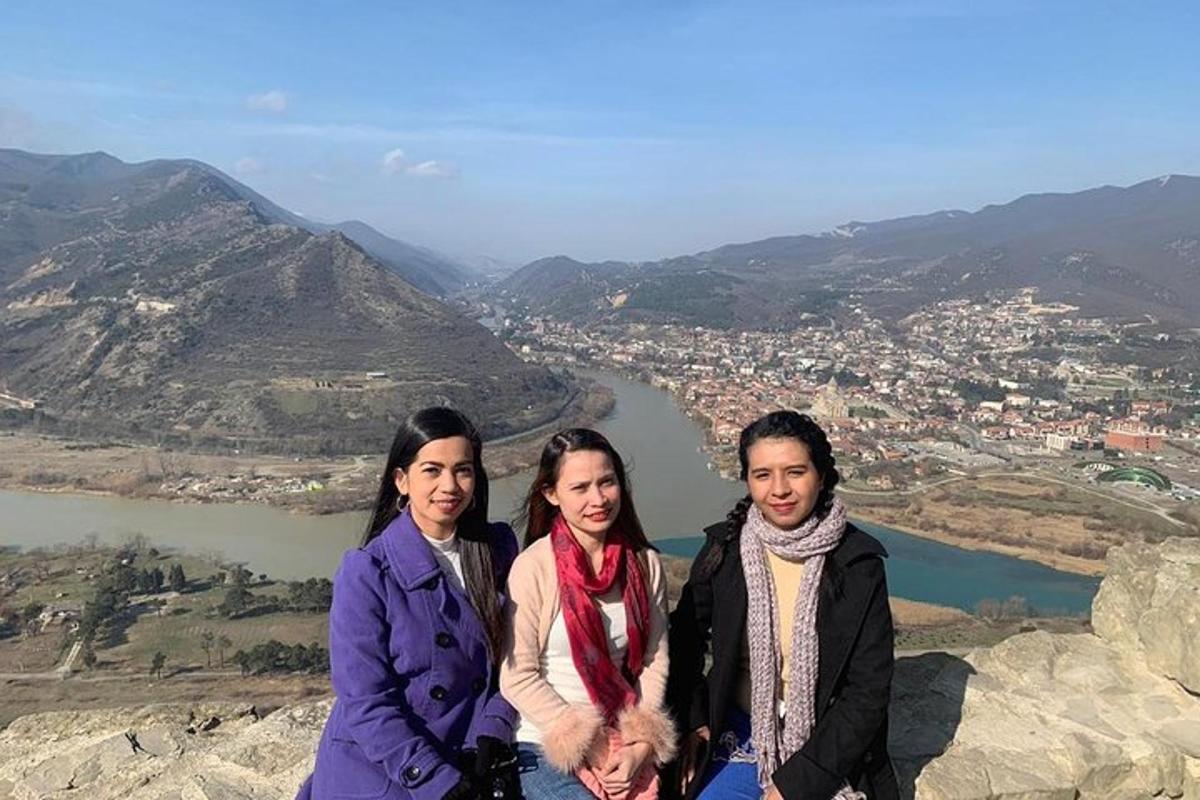 un gruppo di tre donne in piedi sulla cima di una montagna