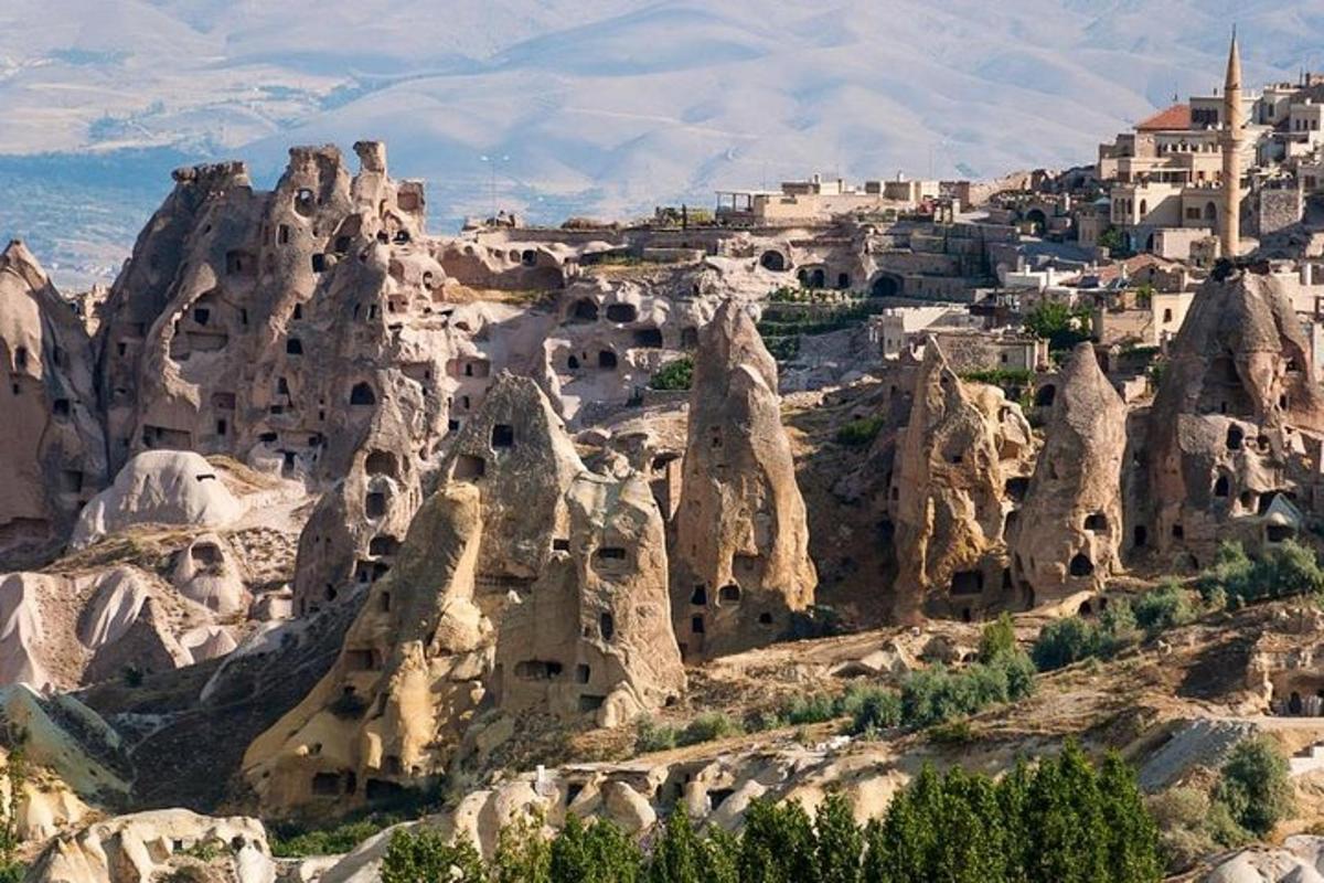 a view of a rocky mountain with dwellings on it