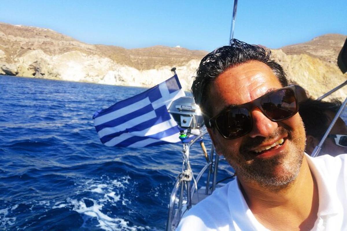 a man wearing sunglasses on a boat in the water