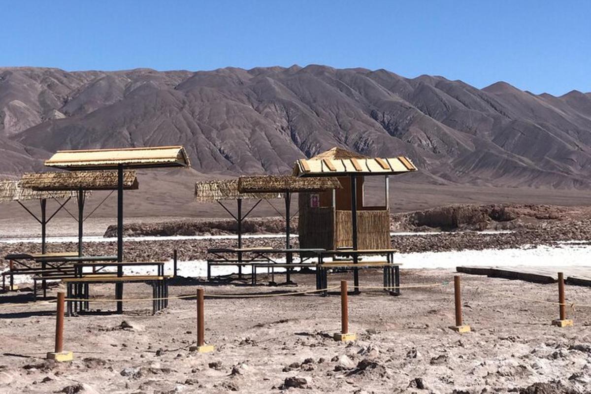 a group of picnic tables with mountains in the background