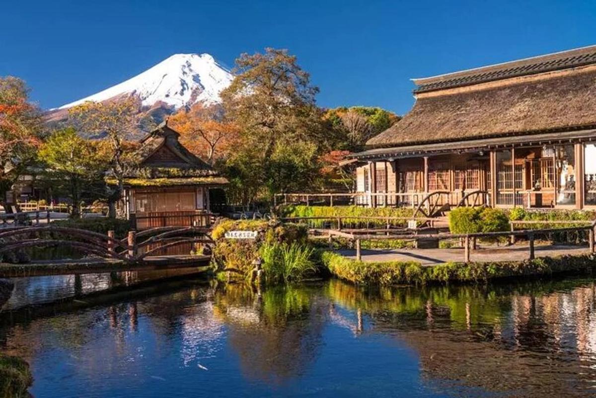 a building next to a river with a mountain in the background