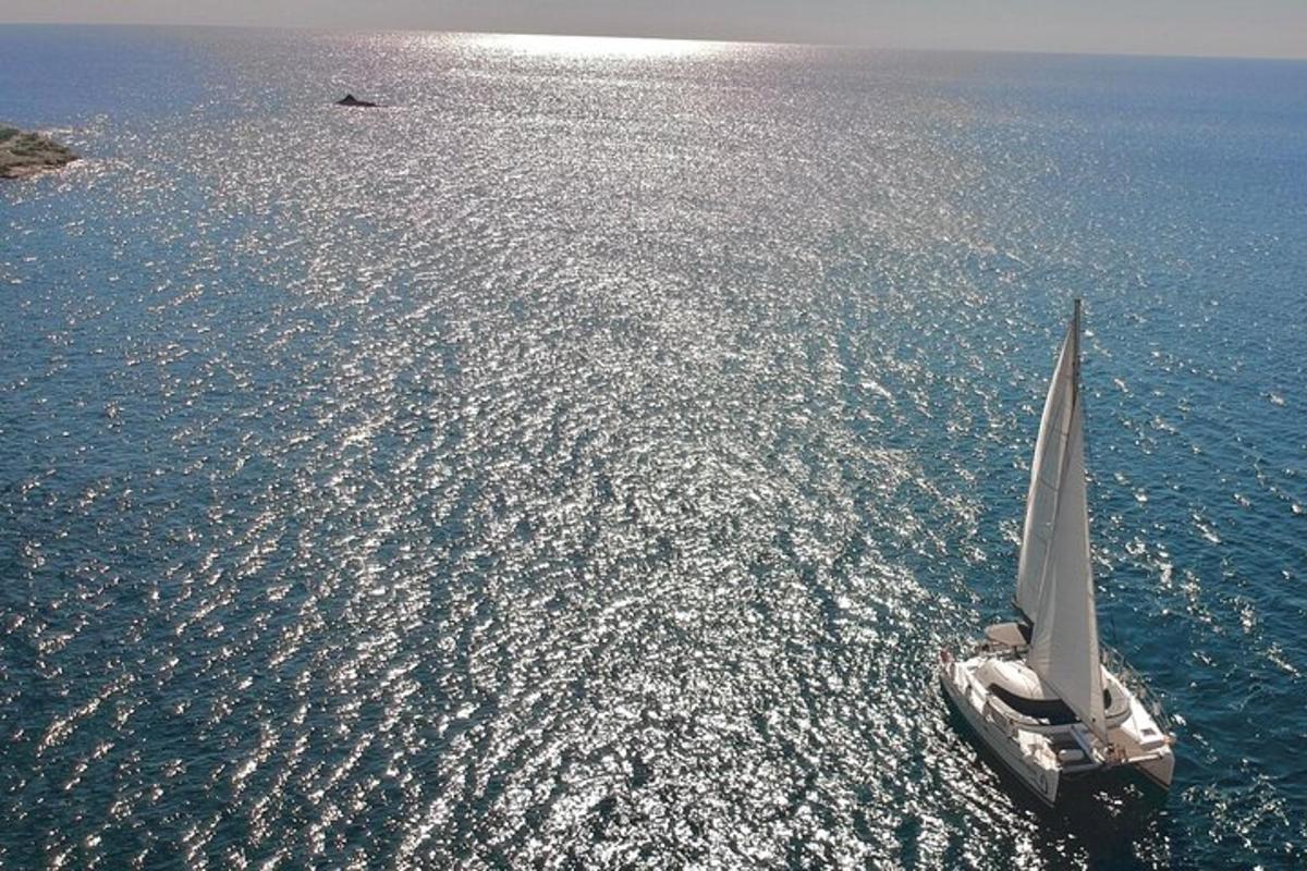 a small sailboat in the water on the ocean