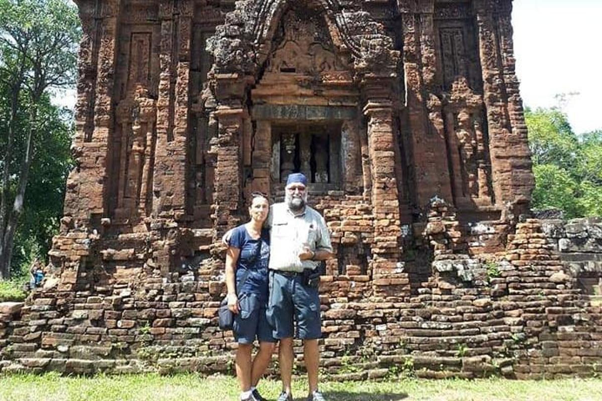 a man and a woman standing in front of a building