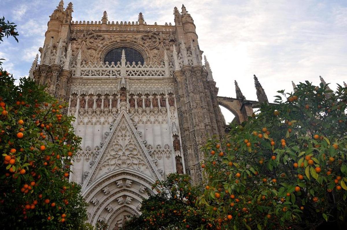 a large tower of a cathedral with orange trees