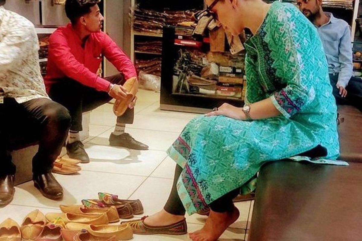a woman sitting on a counter in a shoe store