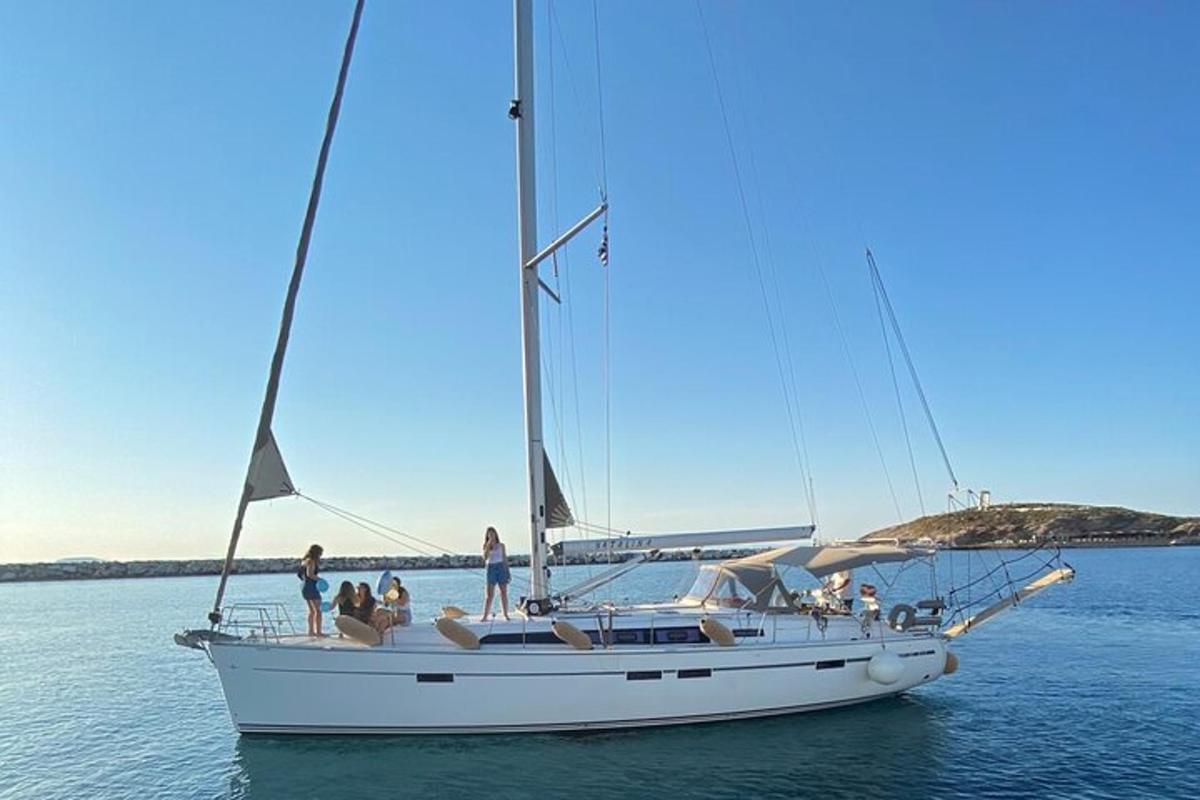 a group of people on a sailboat in the water