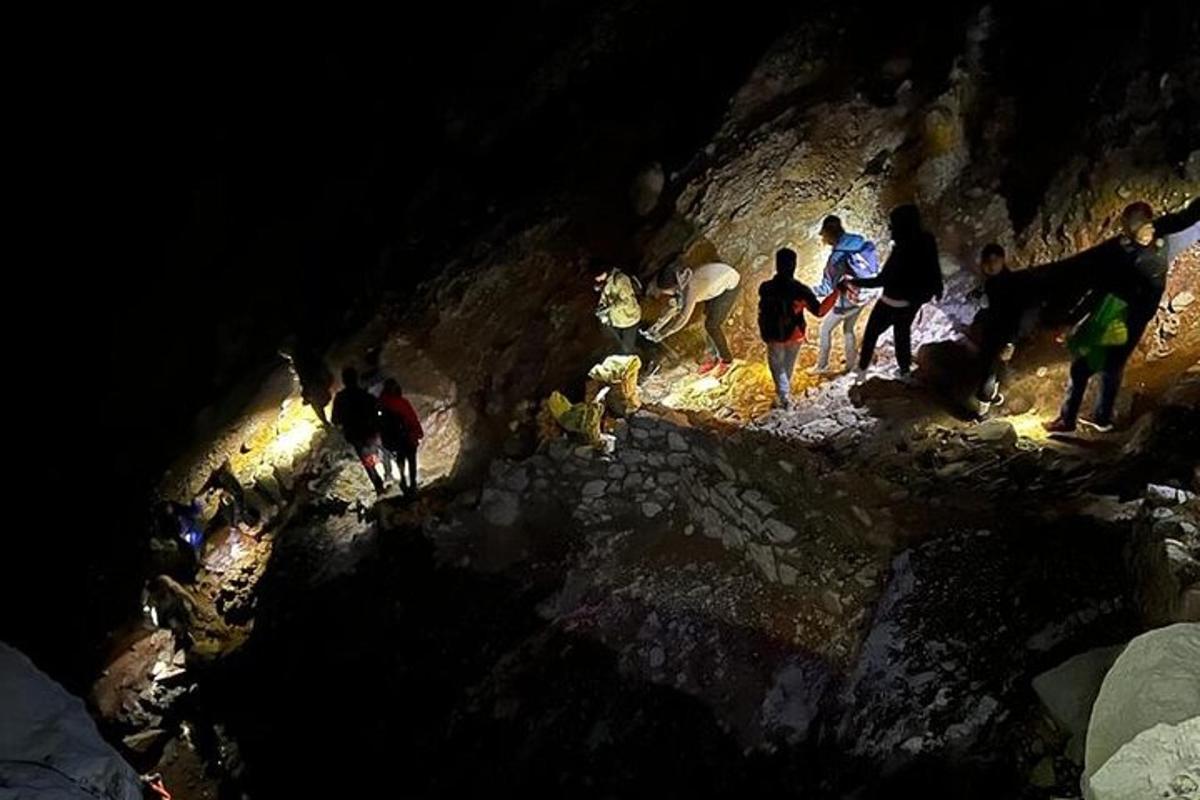 a group of people standing in a cave