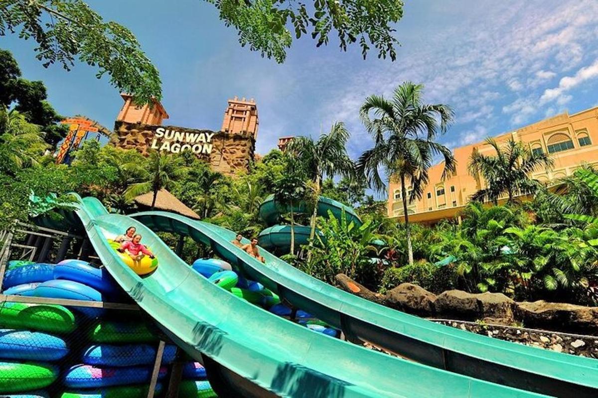 a water slide at a theme park with a roller coaster