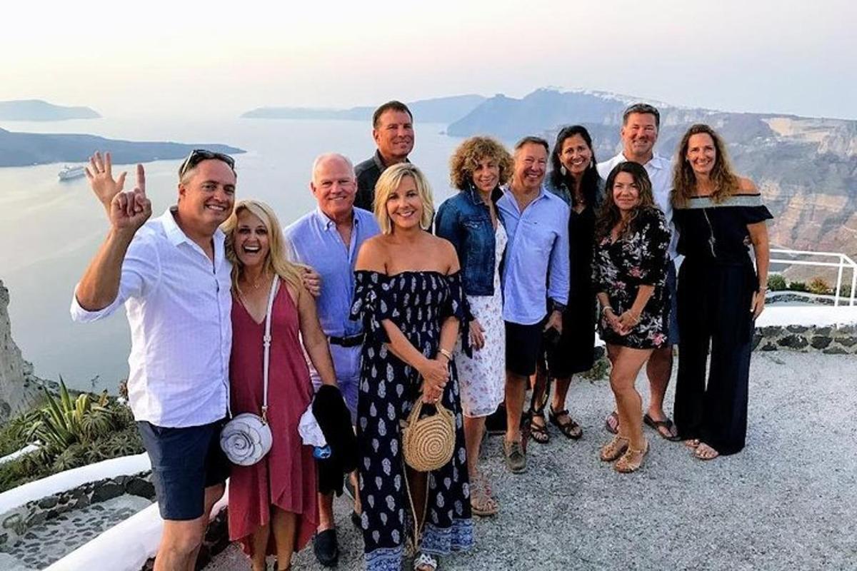 un gruppo di persone in posa per una foto sul lato di una scogliera