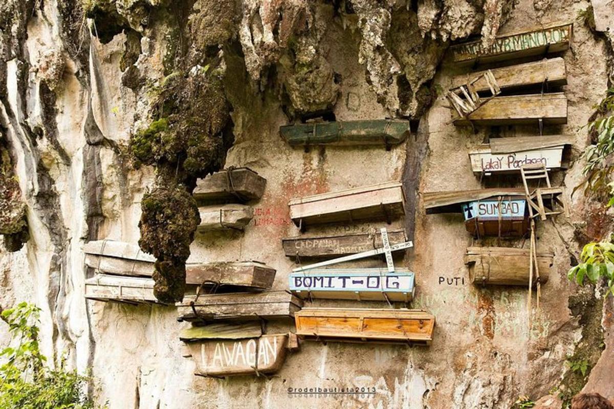 a wall with signs on the side of a mountain