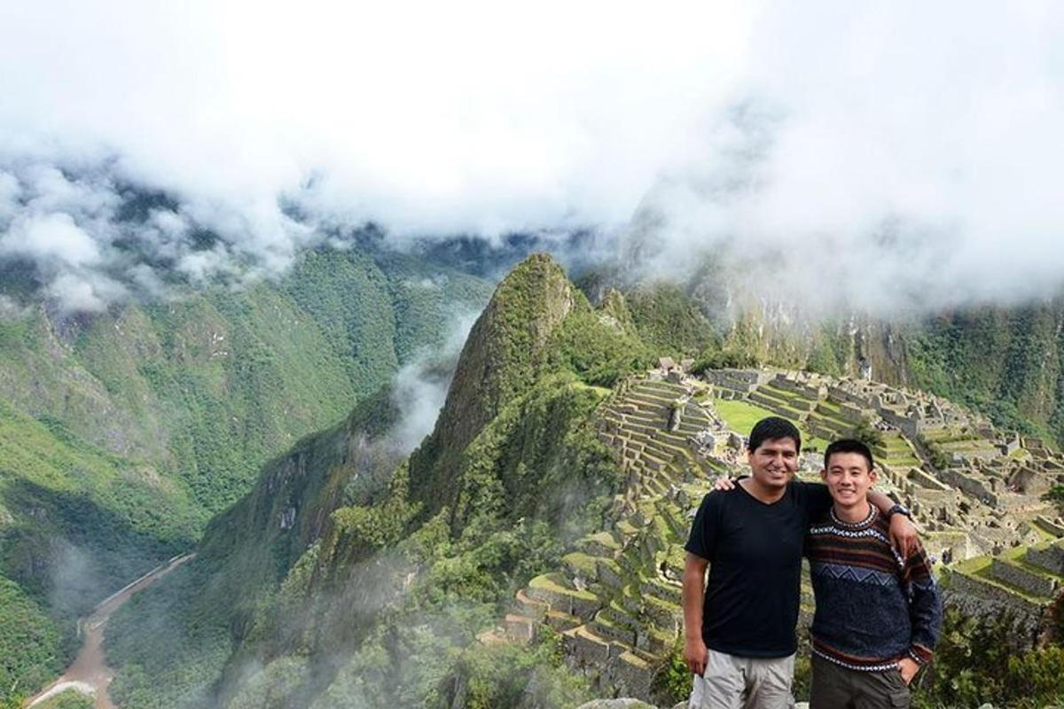 two men are standing on top of a mountain