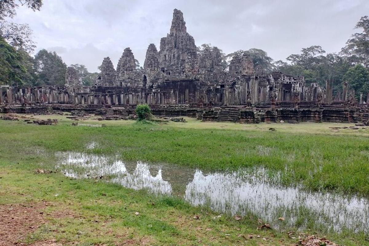 a field in front of an ancient temple