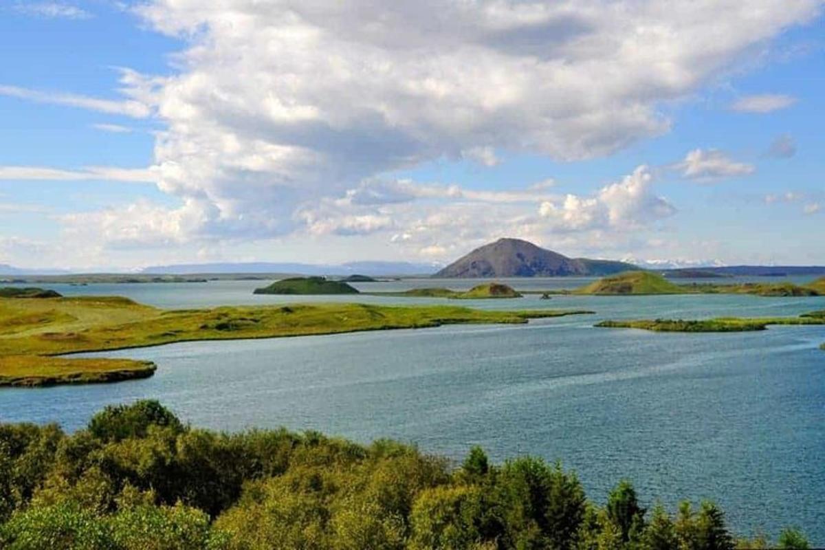 a large body of water with a mountain in the background