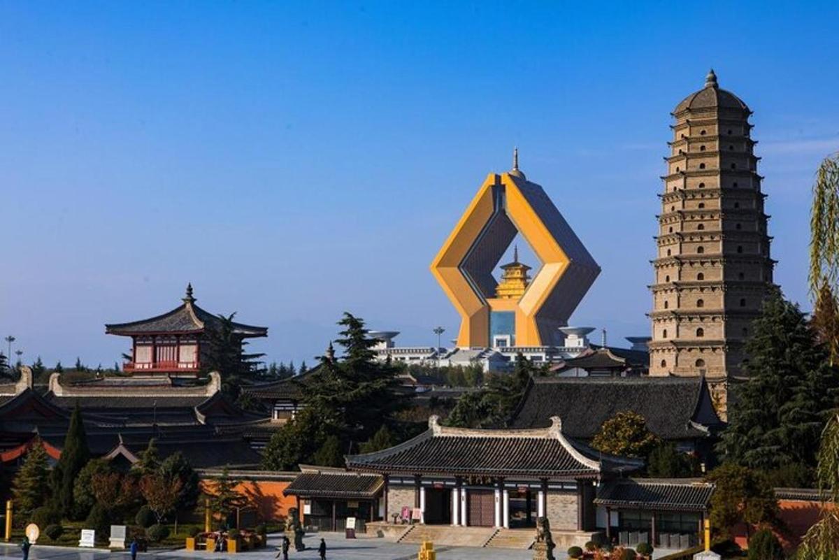 a group of buildings with a large sculpture in the foreground
