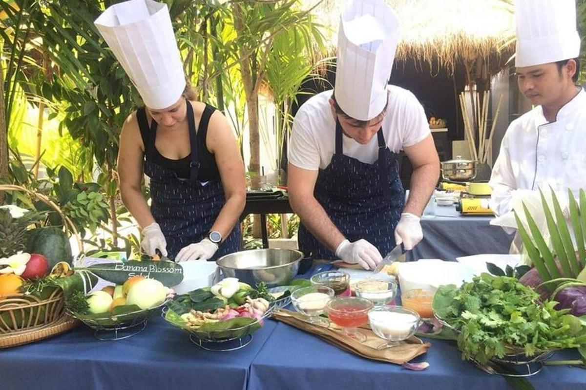 three people in chefs hats preparing food on a table