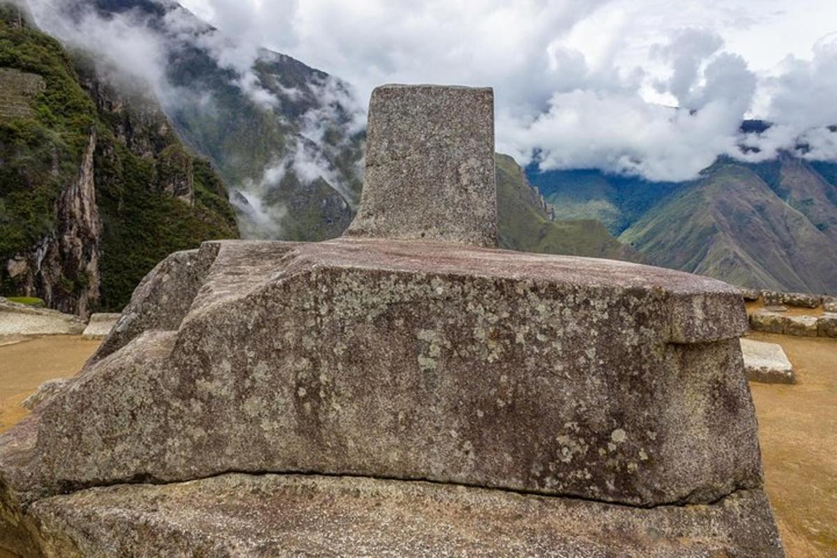 a large rock with a view of a mountain