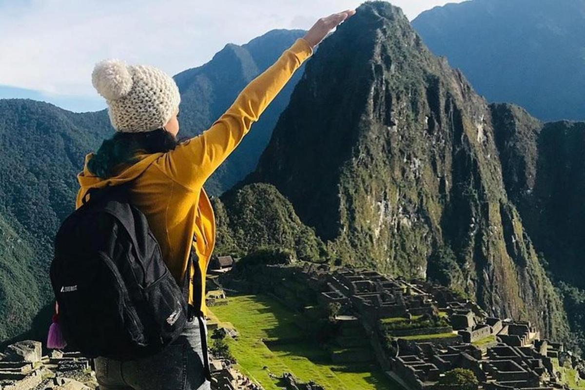 a person standing on top of a mountain with their arms outstretched