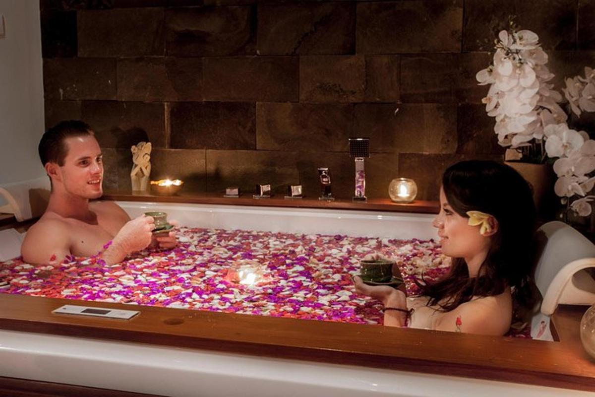 a man and woman sitting in a bathtub covered in candy