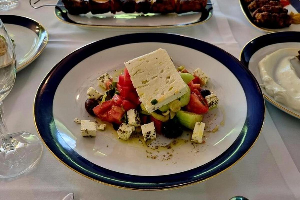 a plate of food with cheese and vegetables on a table