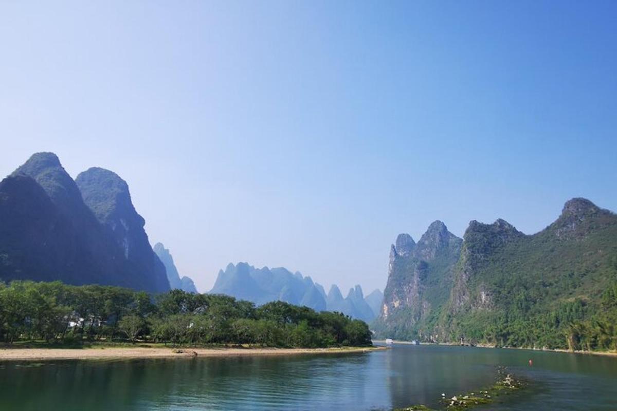 a view of a river with mountains in the background