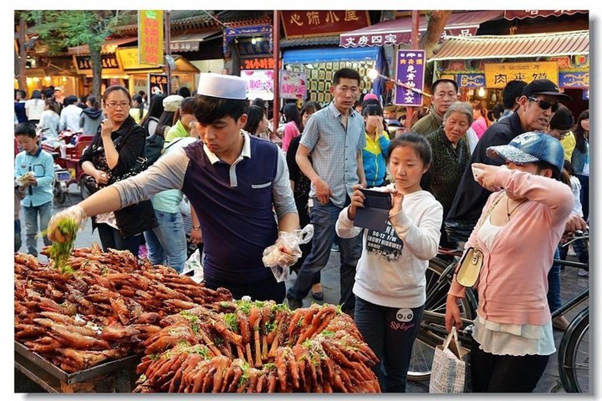 a group of people standing around a market with food