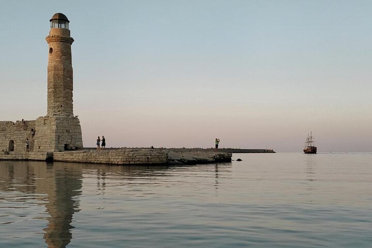 a lighthouse in the water next to a body of water