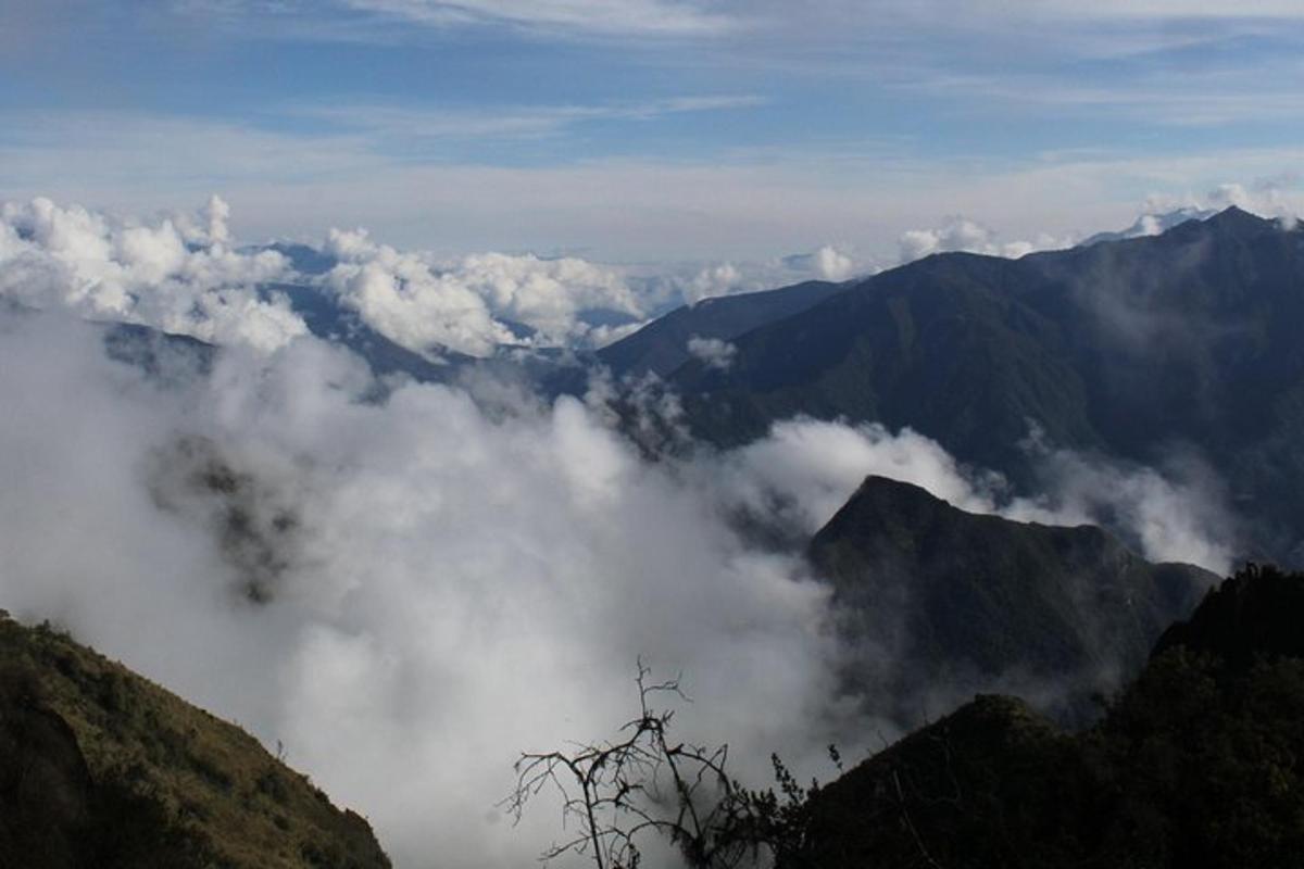 una vista di una catena montuosa con nuvole in primo piano