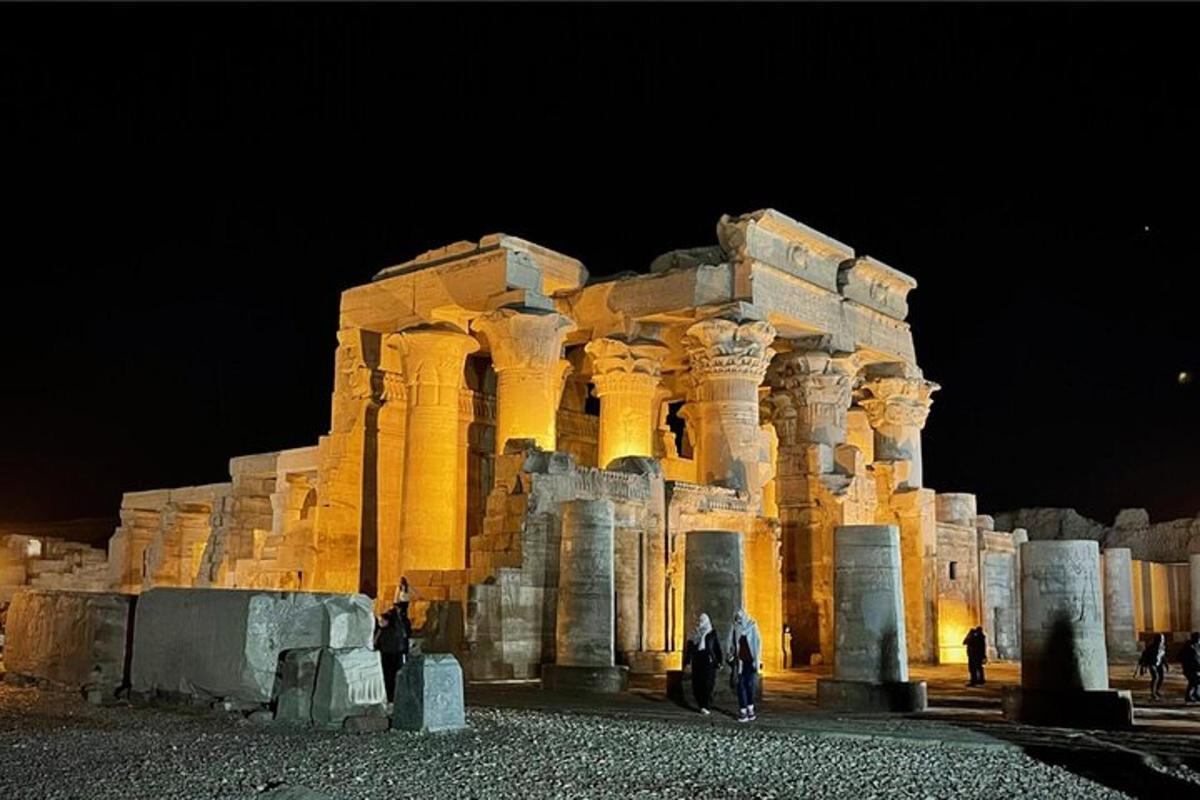 a building with people standing in front of it at night