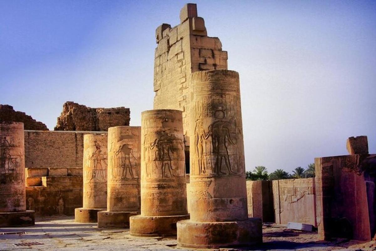 an ancient building with pillars in front of it
