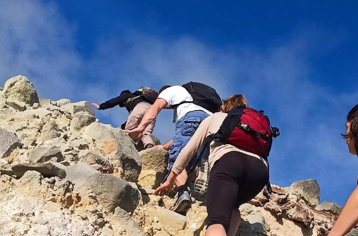 a group of people climbing up a rocky mountain
