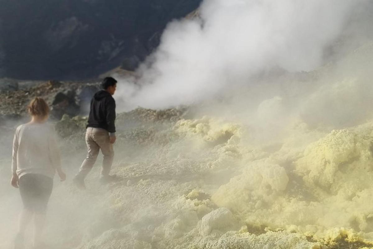 a man and a woman walking through a geyser