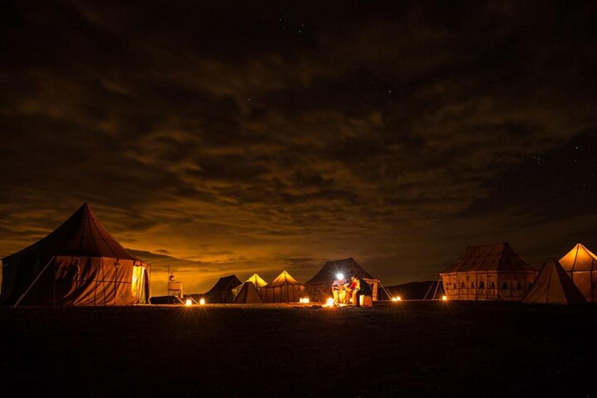 a group of tents in a field at night