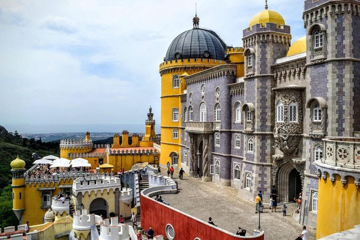 a large yellow and gray building with a dome