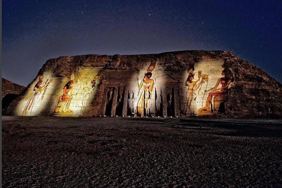 a rock formation with paintings on it at night