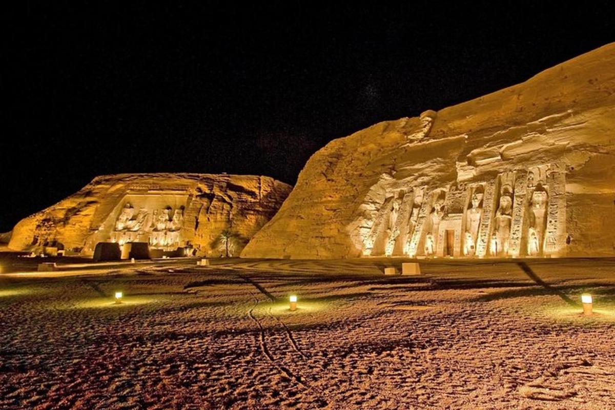 a stone building with lights in front of it at night