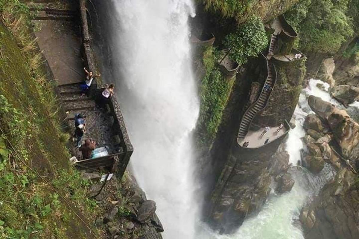 a group of people standing on top of a waterfall