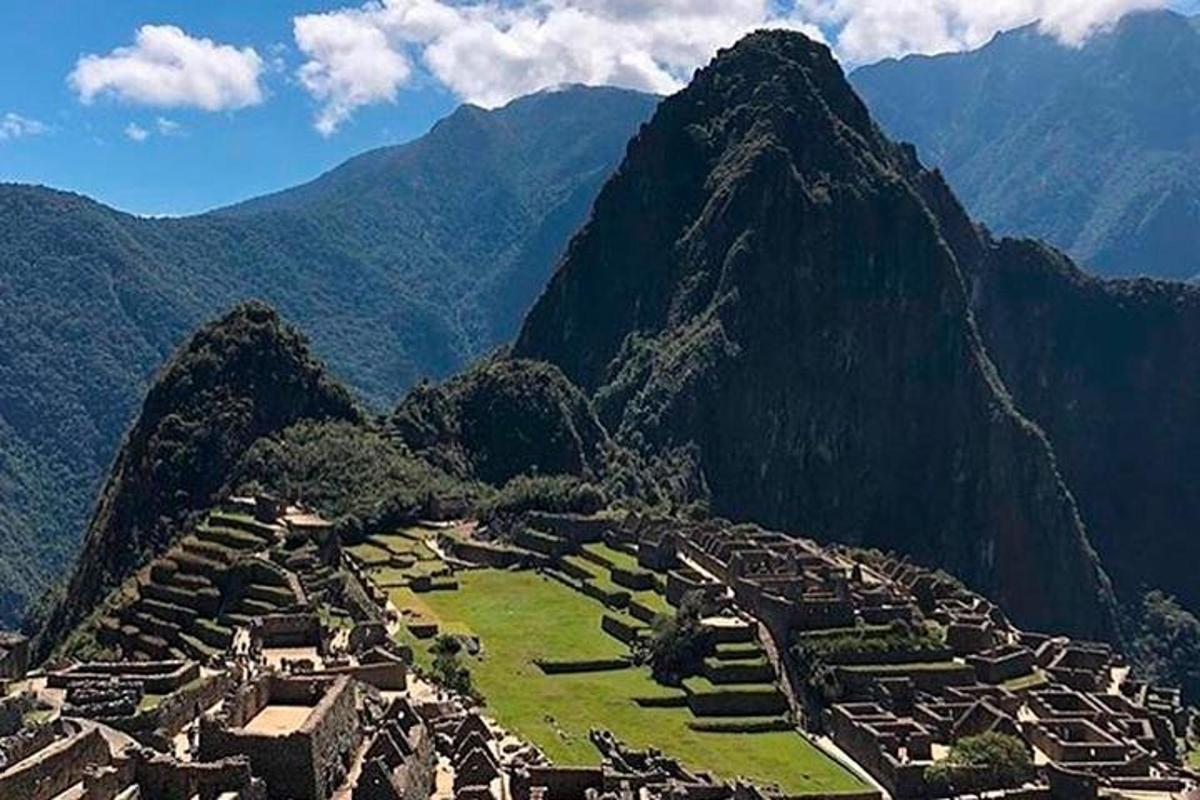 a village on a mountain with mountains in the background