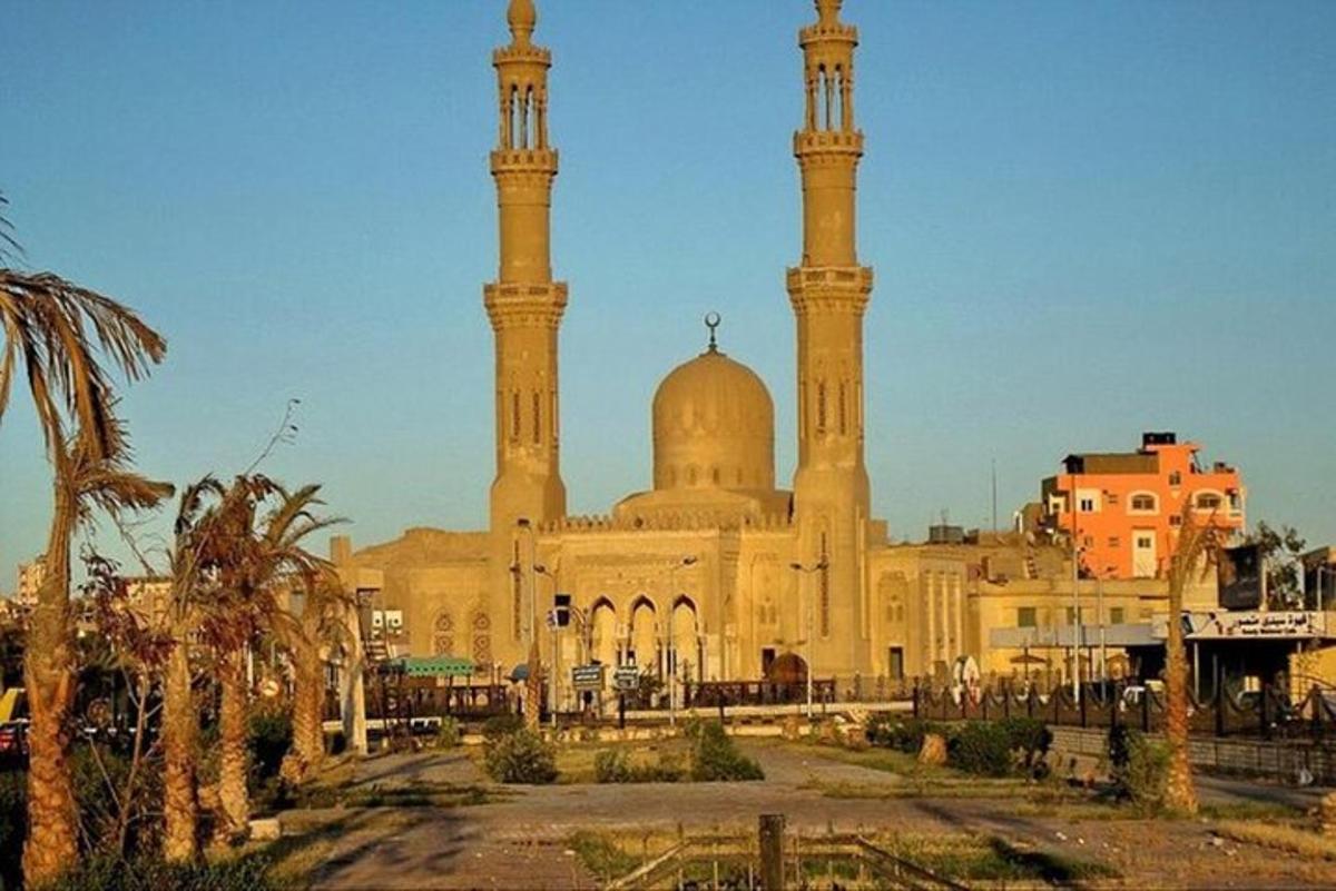 a large building with a mosque with two towers