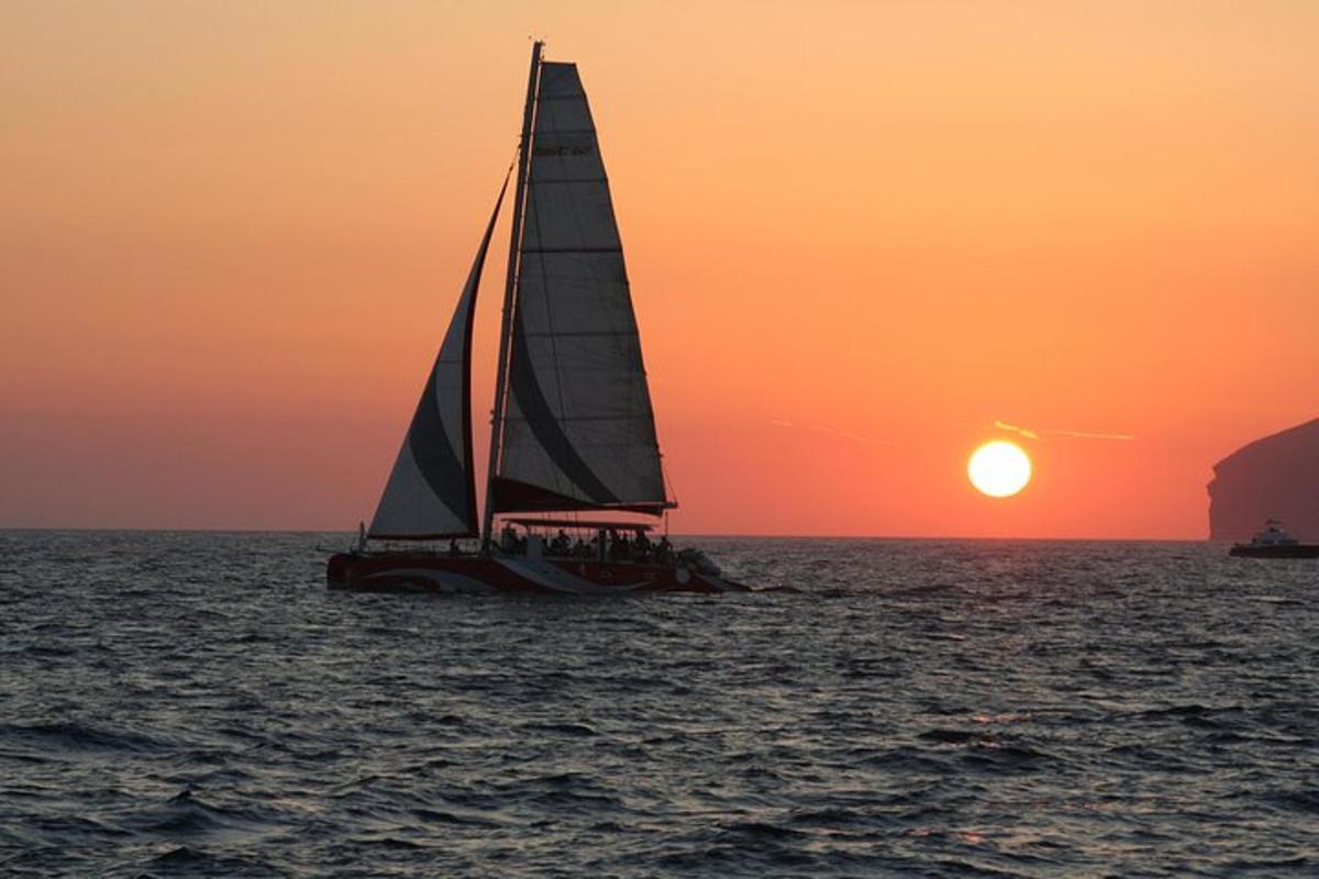 una barca a vela nell'oceano al tramonto