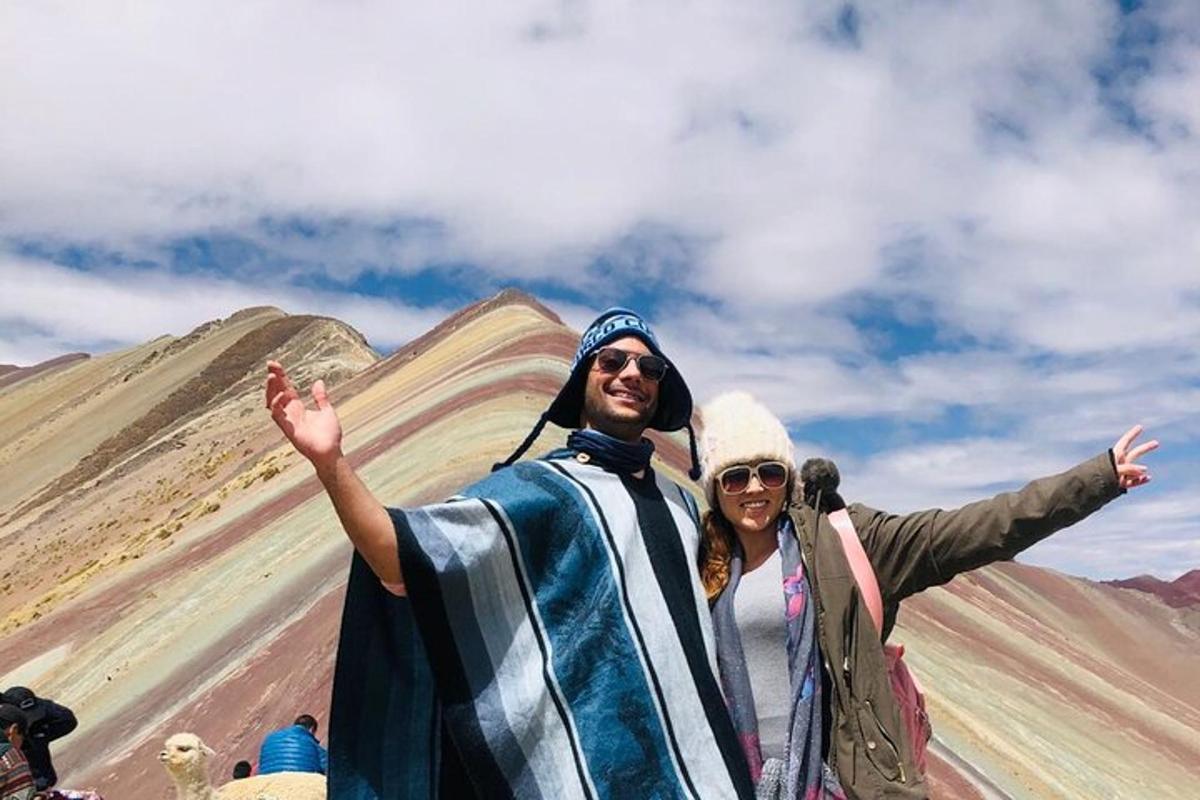 a man and a woman standing in front of a mountain