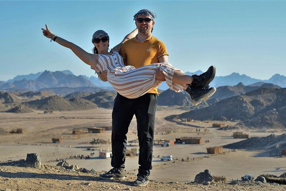 a man and a woman standing on top of a mountain