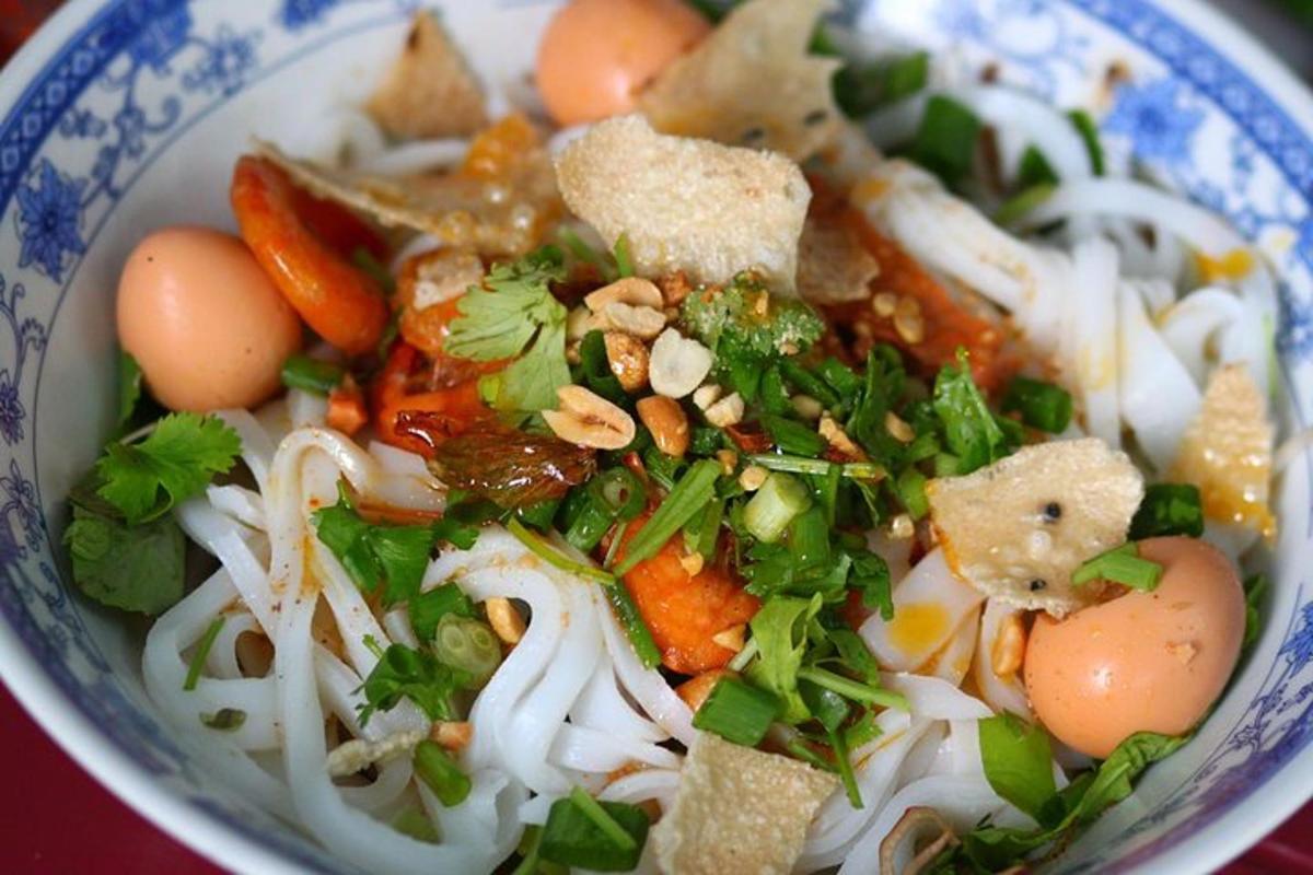 a bowl of soup with vegetables and eggs in it